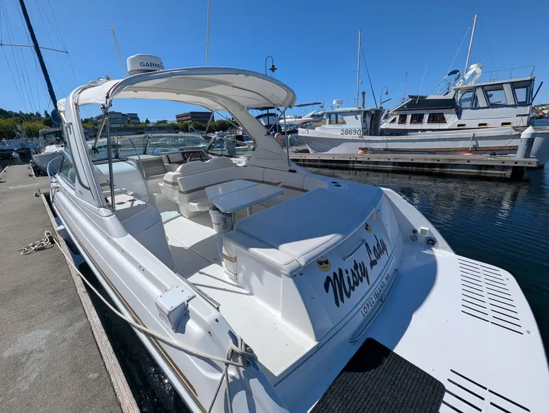 Slide: The Image of 2003 Formula 330 SS boat docked at marina, featuring spacious seating and sleek design. - 5