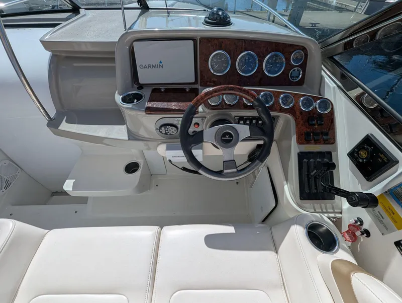 Slide: The Image of Cockpit of a 2003 Formula 330 SS boat with Garmin navigation system and wood-accented dashboard. - 8