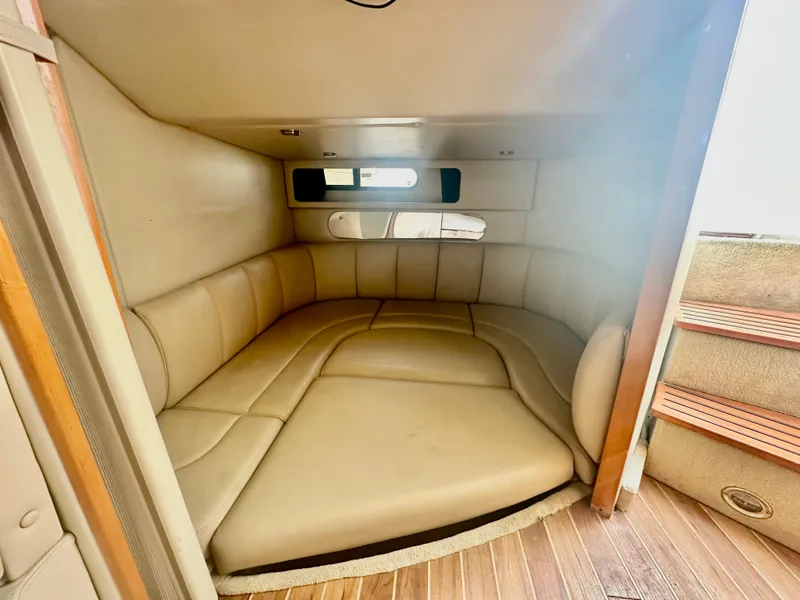 Slide: The Image of 2008 Chaparral 350 Signature cabin interior with beige leather seating and wooden flooring. - 12