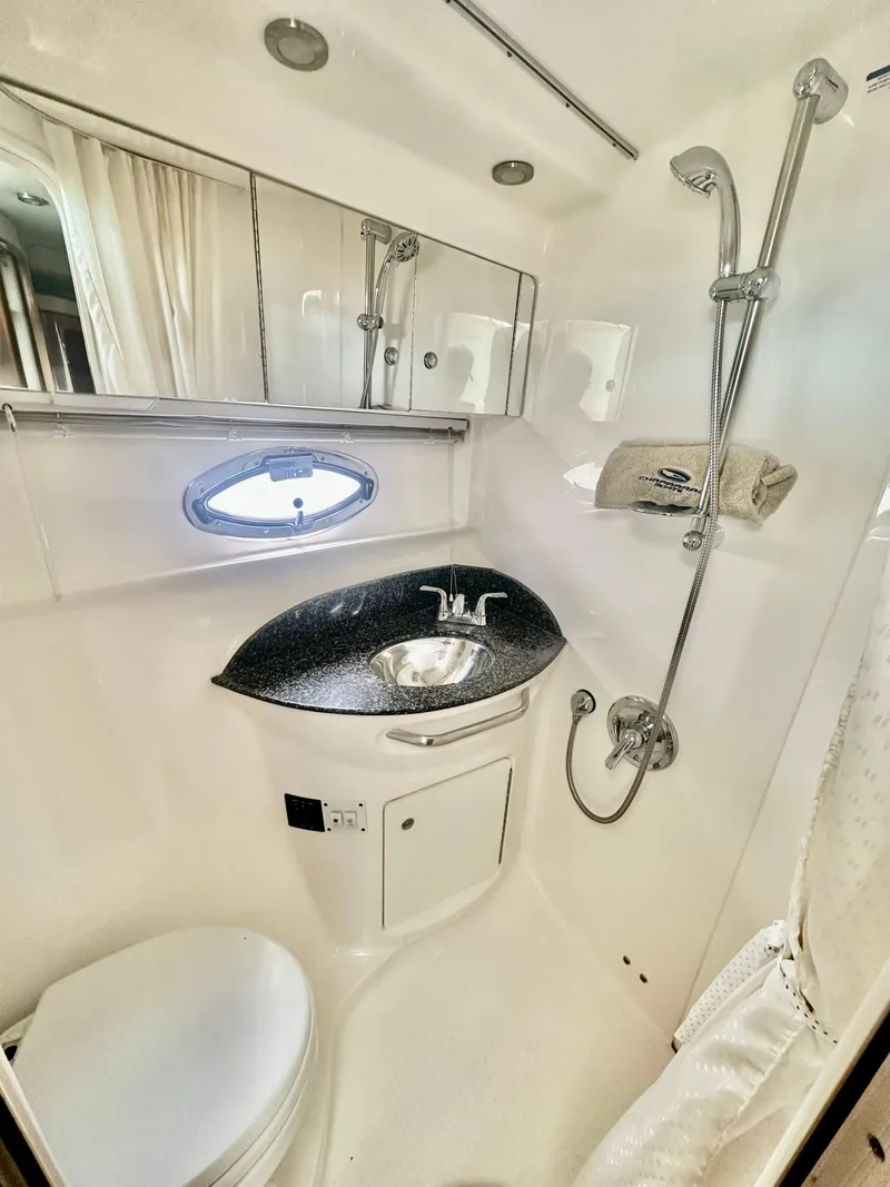 Slide: The Image of 2008 Chaparral 350 Signature boat bathroom with shower, sink, and mirror. - 13
