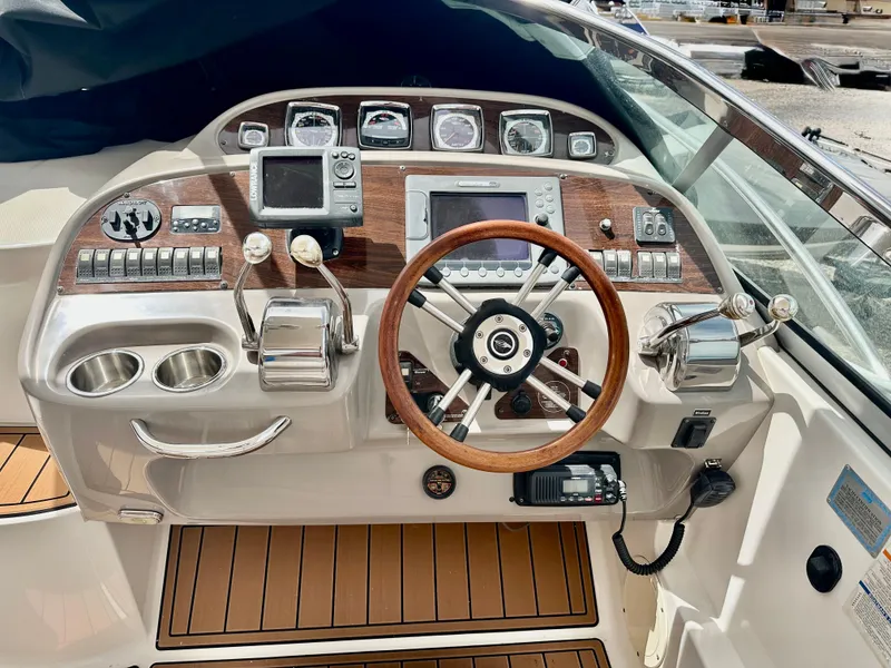 Slide: The Image of 2008 Chaparral 350 Signature boat dashboard with wood accents and modern controls. - 5