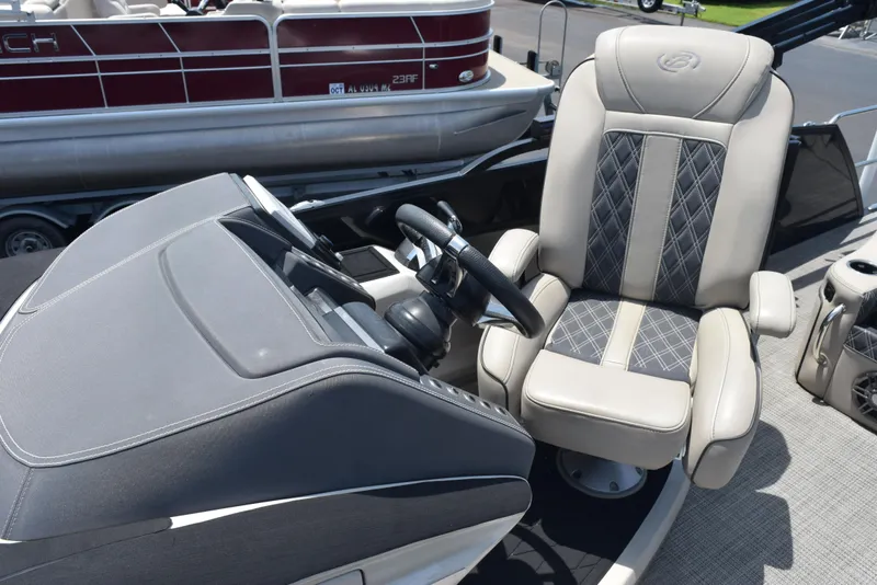 Slide: The Image of Captain's chair and helm of 2022 Barletta L25UC pontoon boat, featuring luxurious seating. - 10