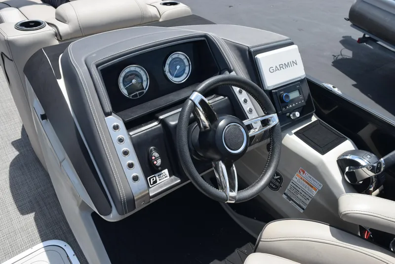 Slide: The Image of 2022 Barletta L25UC boat dashboard with Garmin navigation system and steering wheel. - 12