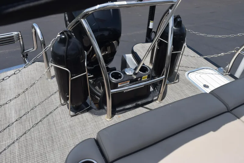 Slide: The Image of 2022 Barletta L25UC boat interior with safety railings and seating area. - 16