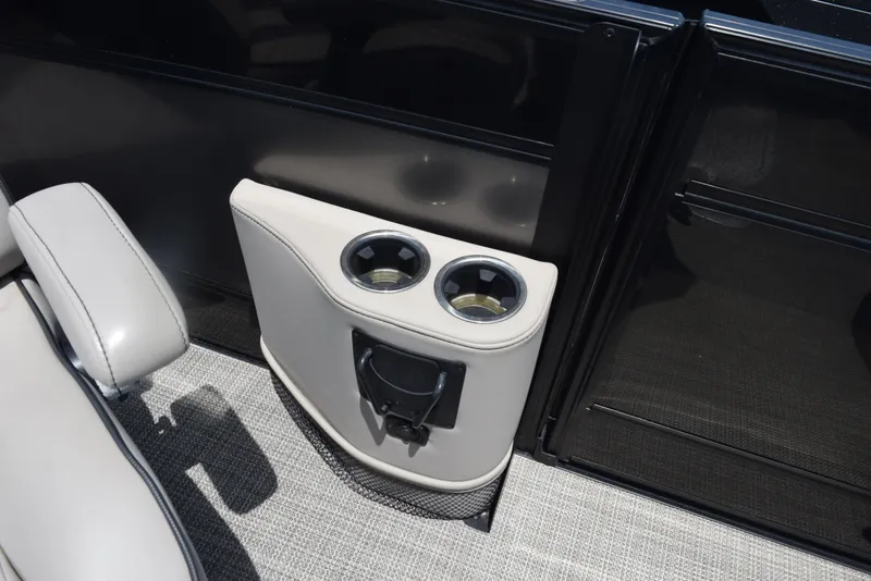 Slide: The Image of Cup holders on 2022 Barletta L25UC boat with beige upholstery and black trim. - 17