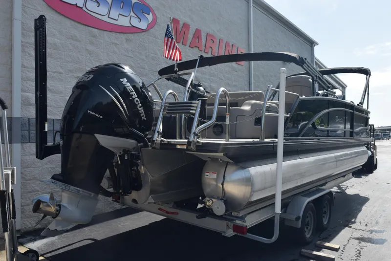 Slide: The Image of 2022 Barletta L25UC pontoon boat with Mercury Verado engine on trailer. - 4