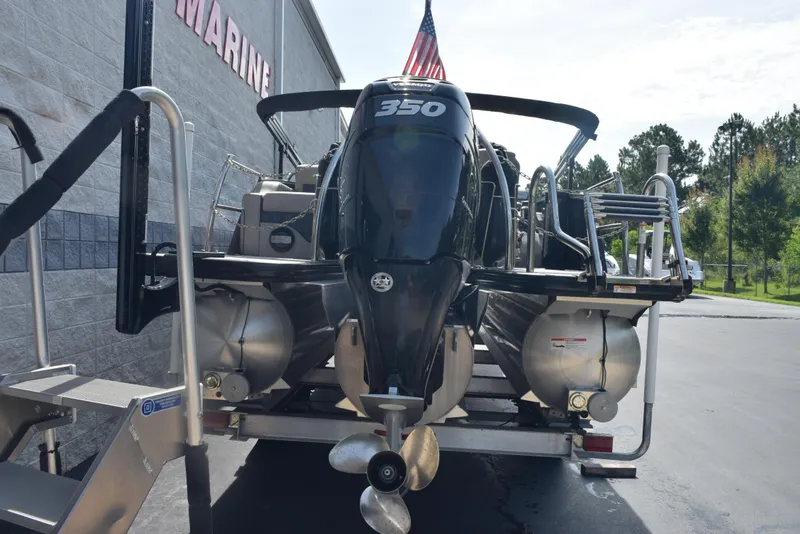 Slide: The Image of 2022 Barletta L25UC pontoon boat with powerful 350 engine, parked outdoors. - 5