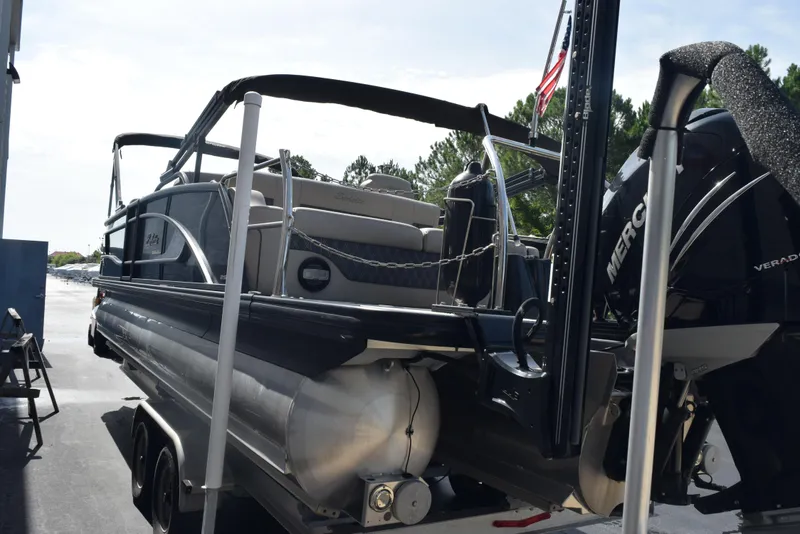 Slide: The Image of 2022 Barletta L25UC pontoon boat with Mercury Verado engine on trailer. - 6