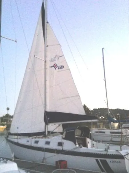 The Image of 1979 Lancer Sloop sailboat docked in a marina, featuring white sails and a sleek design. - 0