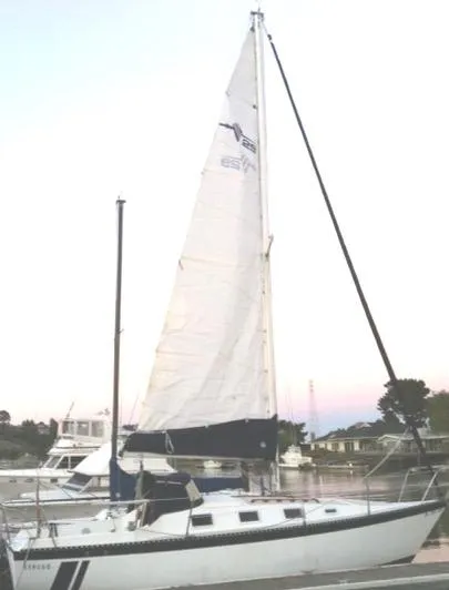 Slide: The Image of 1979 Lancer Sloop sailboat docked at marina during sunset. - 1