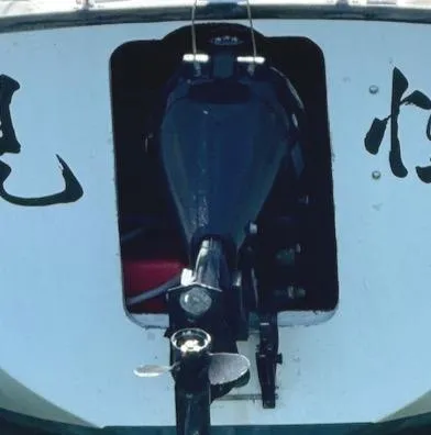 Slide: The Image of 1979 Lancer Sloop boat with outboard motor, featuring distinctive black and white design. - 11