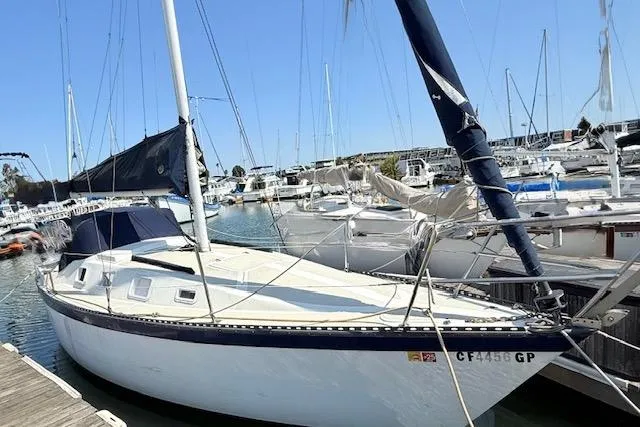 Slide: The Image of 1979 Lancer Sloop sailboat docked in a marina under clear blue skies. - 2