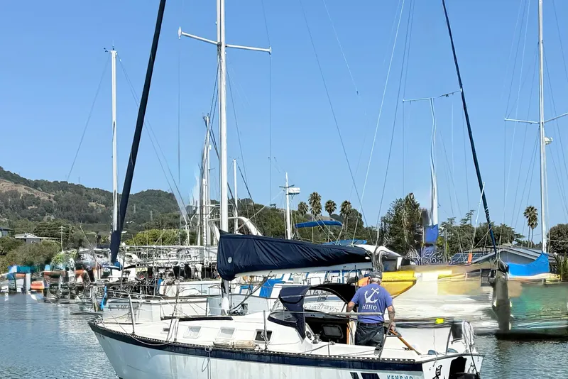 Slide: The Image of 1979 Lancer Sloop sailboat docked in a marina with clear blue skies. - 5