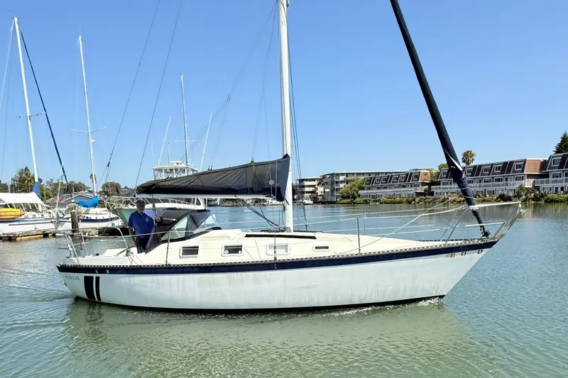 Slide: The Image of 1979 Lancer Sloop sailboat docked in a marina under clear blue skies. - 7