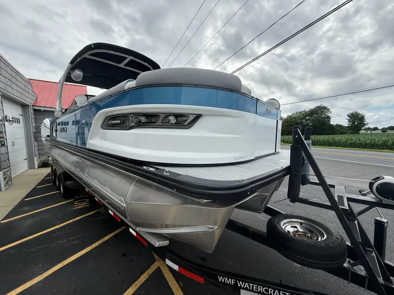 Slide: The Image of 2025 Avalon 2785 Excalibur LTD ELW boat on trailer, featuring twin Mercury Racing 500R engines. - 10