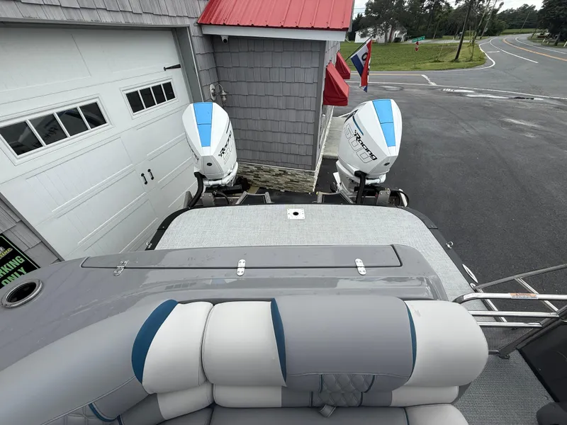 Slide: The Image of 2025 Avalon 2785 Excalibur LTD ELW with twin Mercury Racing 500R engines, docked near garage. - 14