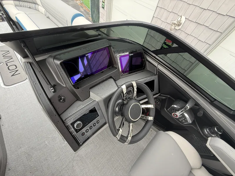 Slide: The Image of 2025 Avalon 2785 Excalibur LTD ELW boat dashboard with joystick controls and modern displays. - 27