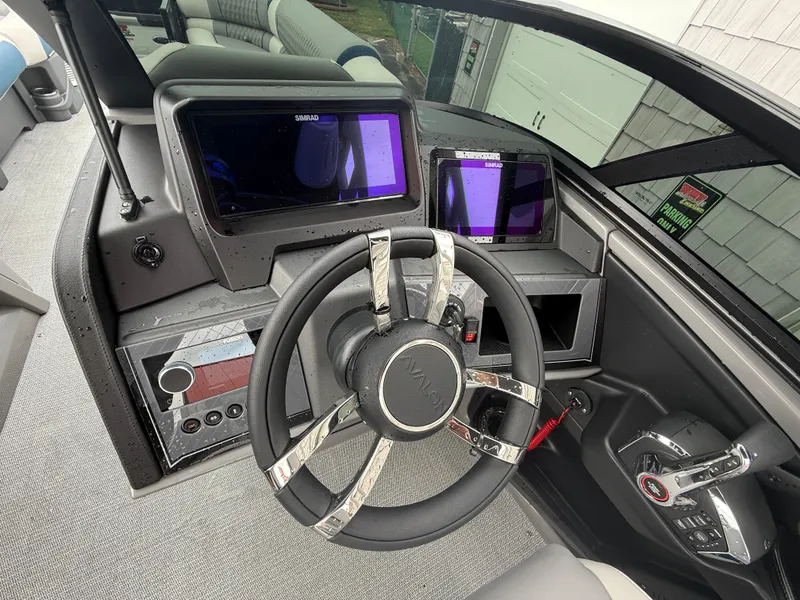 Slide: The Image of 2025 Avalon 2785 Excalibur LTD ELW boat dashboard with joystick controls and Simrad displays. - 29