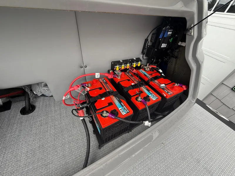 Slide: The Image of Battery compartment of 2025 Avalon 2785 Excalibur LTD ELW boat with wiring and controls. - 36