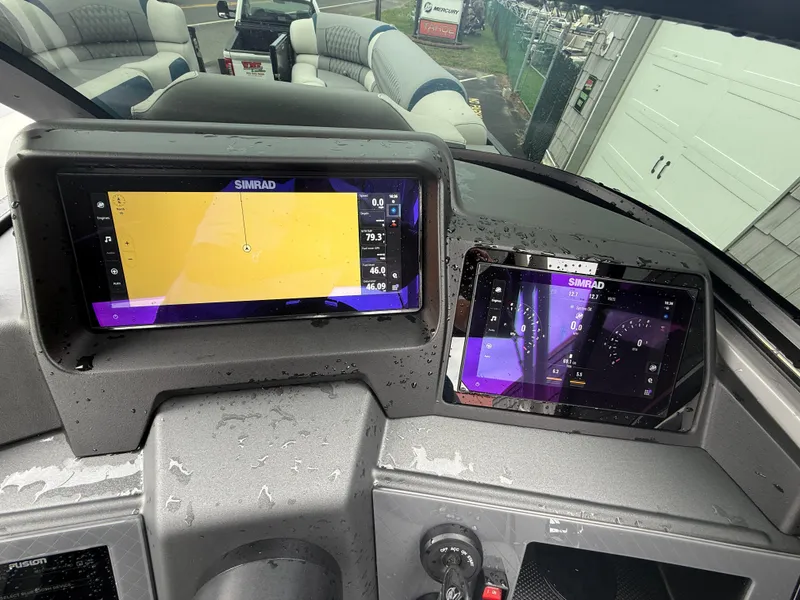 Slide: The Image of Dashboard of 2025 Avalon 2785 Excalibur LTD ELW with Simrad displays and joystick controls. - 37