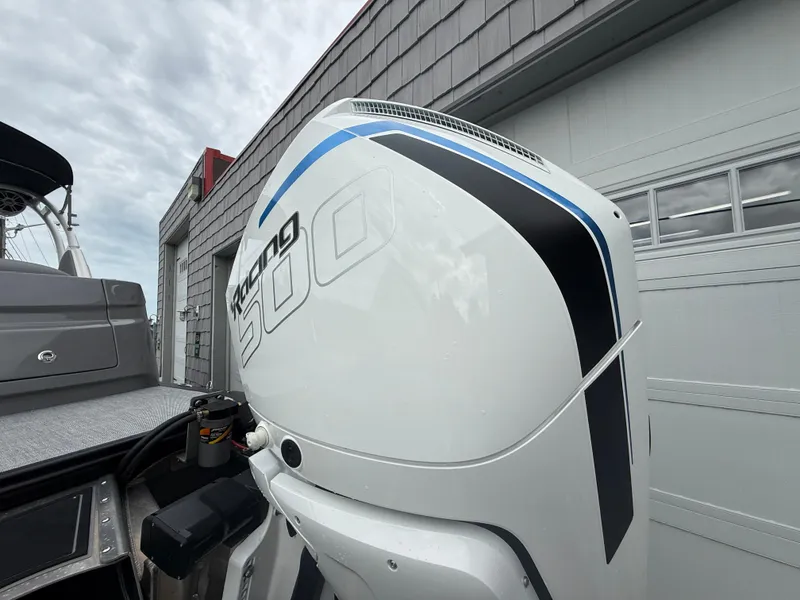 Slide: The Image of 2025 Avalon 2785 Excalibur LTD ELW with Mercury Racing 500R engine, docked near a building. - 8