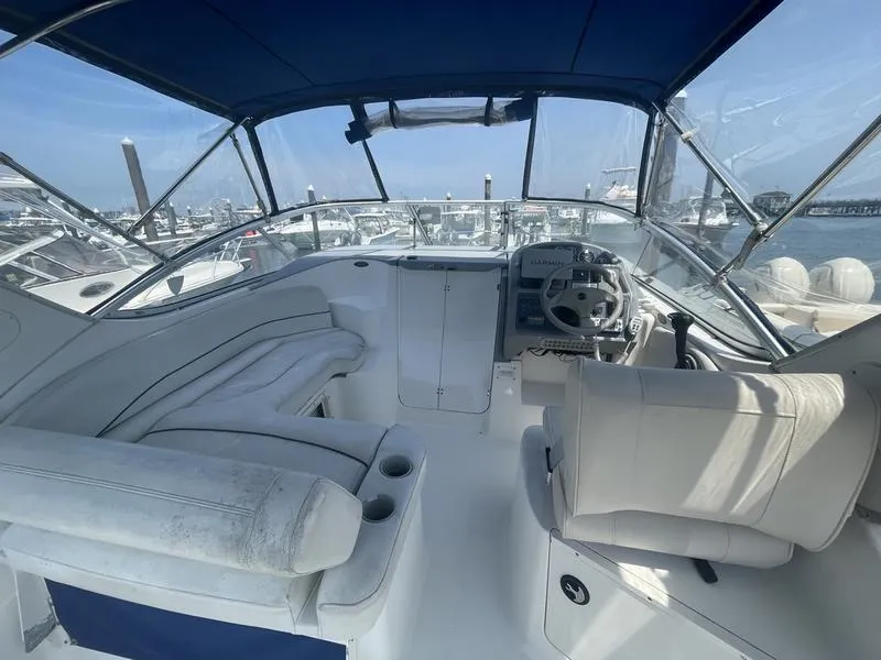 Slide: The Image of Interior view of a 2004 Bayliner 285 boat with seating and steering wheel. - 12