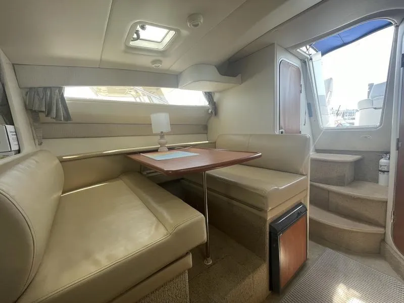 Slide: The Image of Interior of 2004 Bayliner 285 boat with dining area and seating. - 14