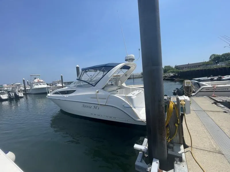 Slide: The Image of 2004 Bayliner 285 boat docked at marina under clear blue sky. - 4