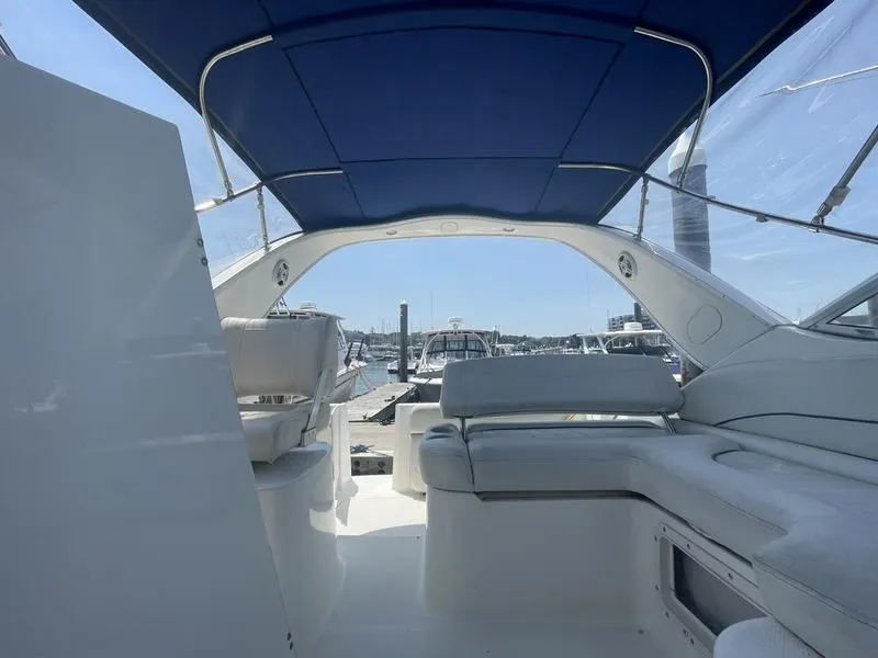Slide: The Image of Interior view of a 2004 Bayliner 285 boat with blue canopy and white seating. - 5