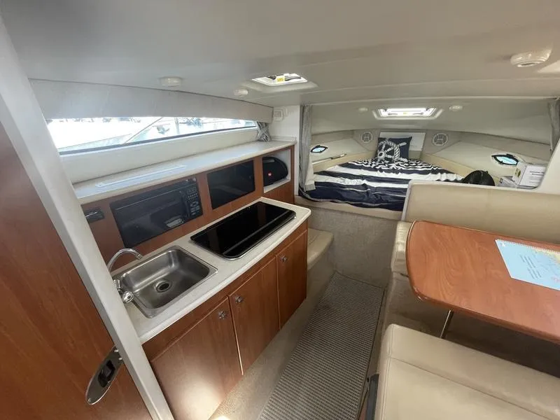 Slide: The Image of Interior of 2004 Bayliner 285 boat with kitchenette, dining area, and sleeping quarters. - 9