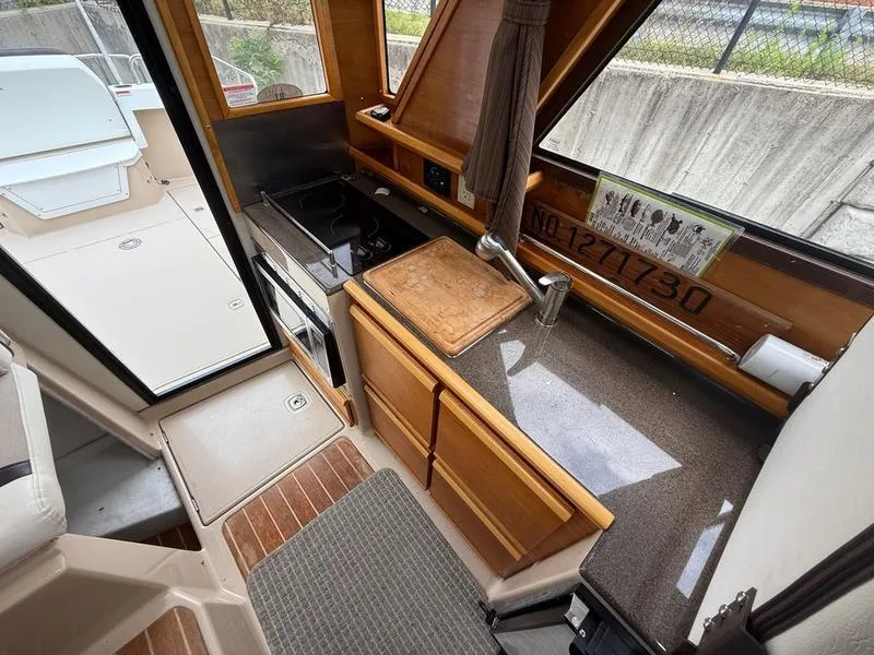 Slide: The Image of Interior of 2016 Cutwater 288 C boat with compact kitchen area. - 12