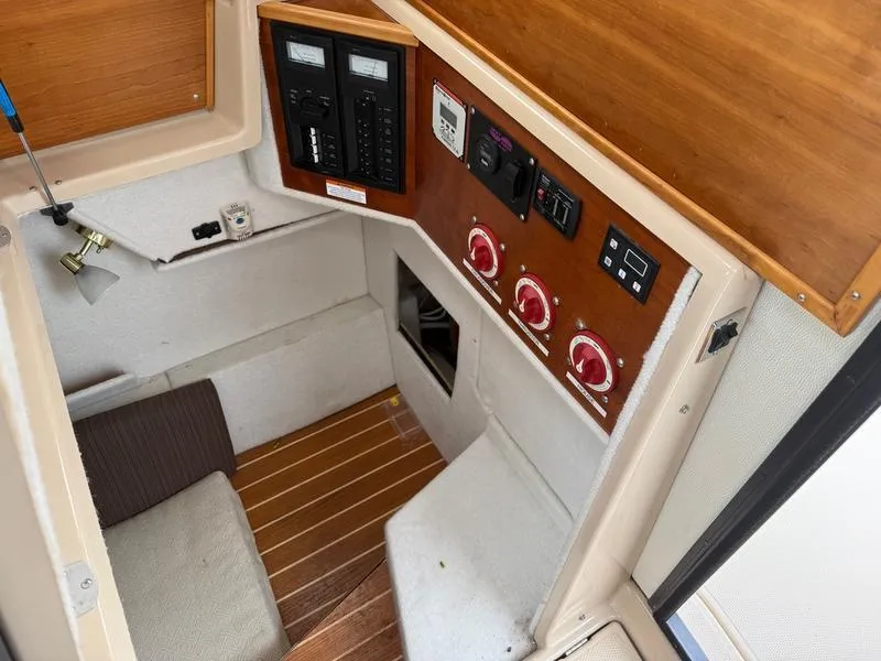 Slide: The Image of Interior of a 2016 Cutwater 288 C boat, featuring control panels and seating area. - 14
