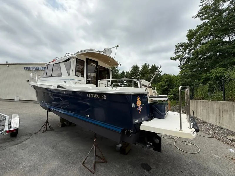 Slide: The Image of 2016 Cutwater 288 C boat on dry dock, blue hull, outdoor setting. - 5