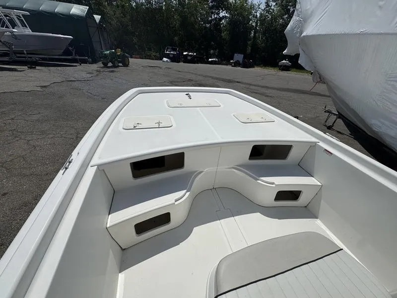 Slide: The Image of 2017 Mako 21 Pro Skiff CC boat interior with seating and storage compartments. - 10