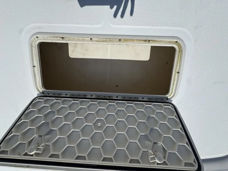 Slide: The Image of Open storage compartment on a 2017 Mako 21 Pro Skiff CC boat. - 9