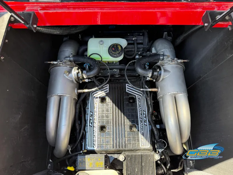 Slide: The Image of Engine compartment of a 2021 Malibu M240 boat, featuring a supercharged engine. - 25