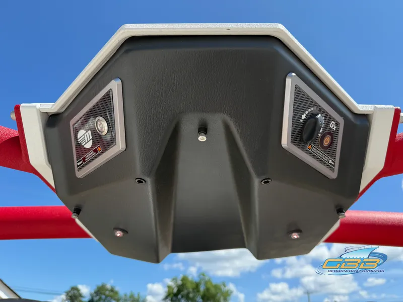 Slide: The Image of 2021 Malibu M240 boat control panel with red accents against blue sky. - 37