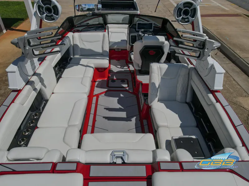 Slide: The Image of 2021 Malibu M240 boat interior with white seating and advanced audio system. - 5