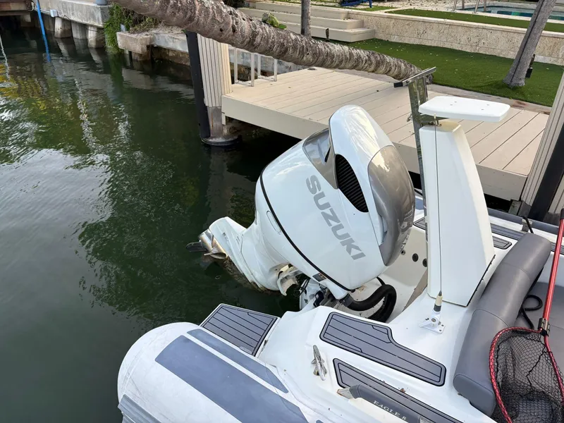 Slide: The Image of 2021 Brig 350 Merc boat with Suzuki outboard motor docked by the water. - 10