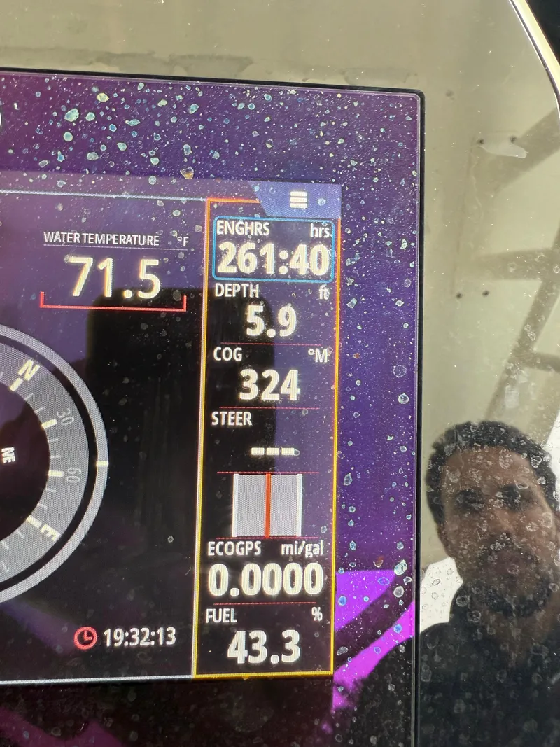 Slide: The Image of Display screen of a 2021 Brig 350 Merc showing engine hours, depth, and fuel percentage. - 18