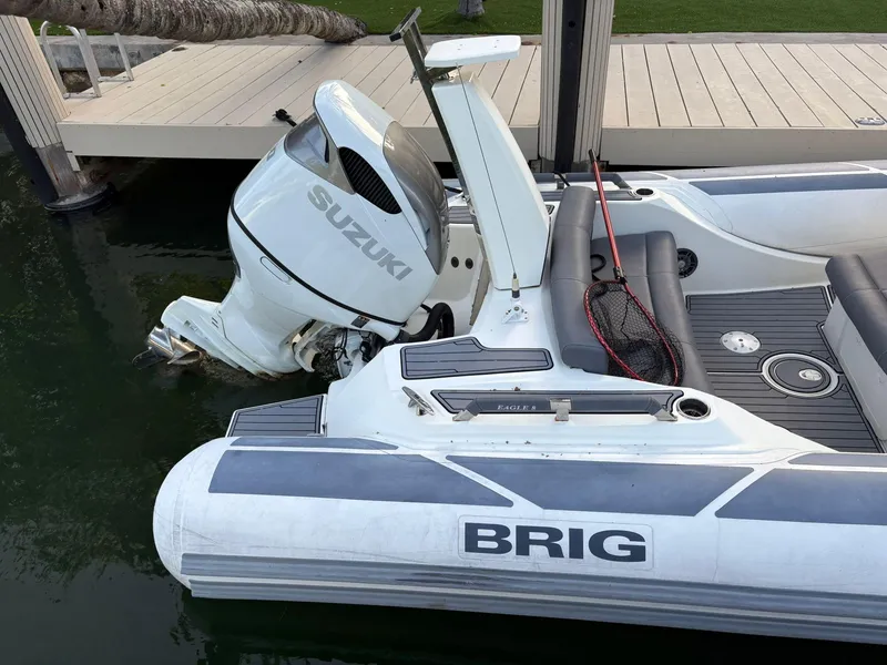 Slide: The Image of 2021 Brig 350 Merc boat with Suzuki outboard motor docked by wooden pier. - 20