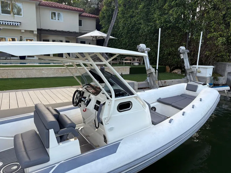 Slide: The Image of 2021 Brig 350 Merc inflatable boat docked near a modern house. - 21