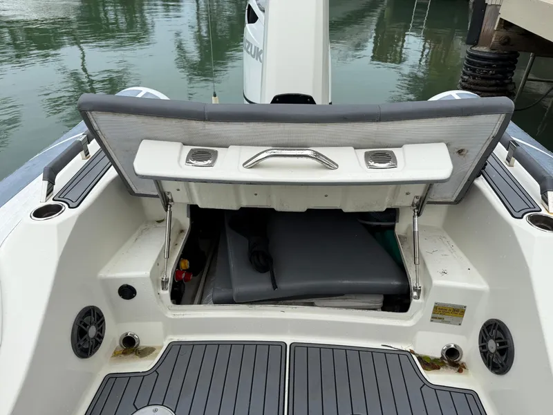 Slide: The Image of 2021 Brig 350 Merc boat with open storage compartment, docked by water. - 4