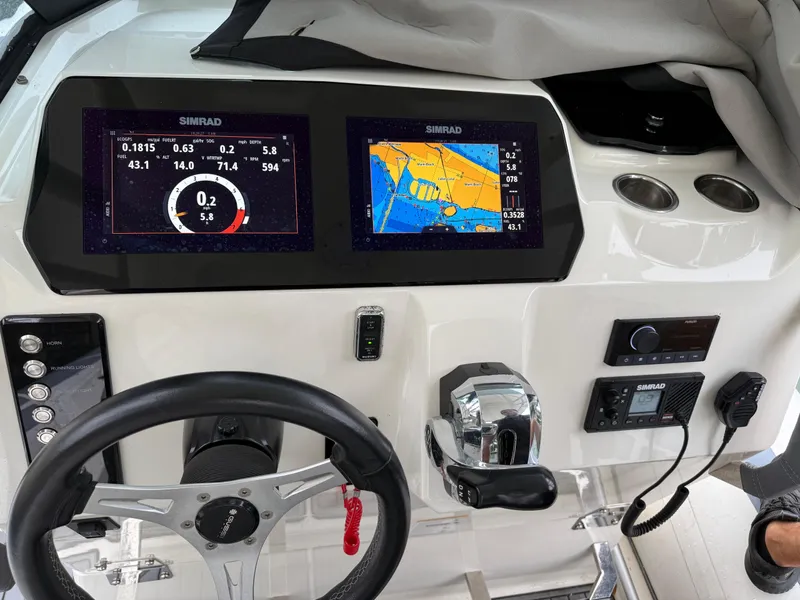 Slide: The Image of Control panel of 2021 Brig 350 Merc boat with Simrad navigation displays. - 8