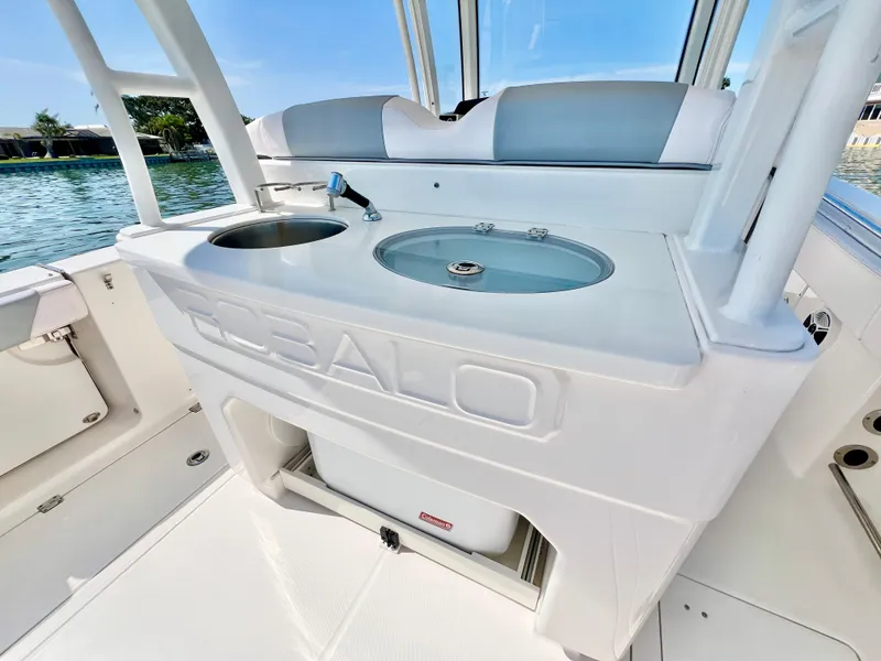Slide: The Image of 2020 Robalo R302 Center Console boat interior with sink and storage. - 12
