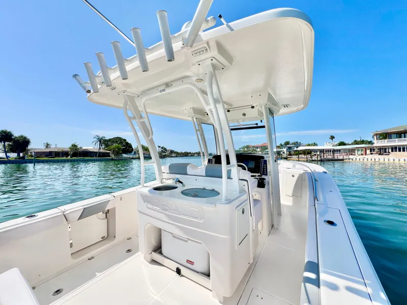 Slide: The Image of 2020 Robalo R302 Center Console boat on calm water, showcasing sleek design and spacious deck. - 13