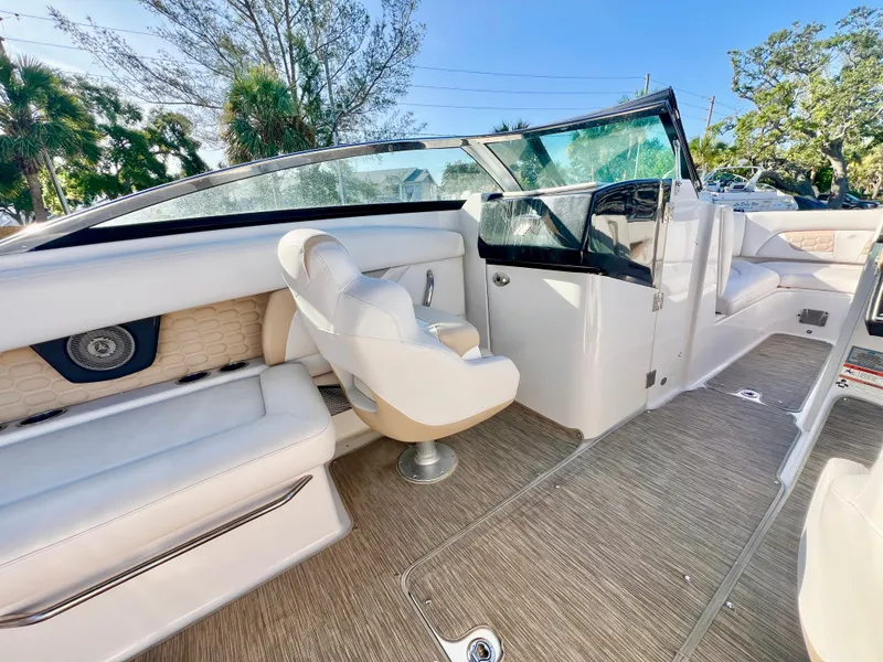 Slide: The Image of 2018 Four Winns HD270 OB boat interior with white seating and modern design. - 11