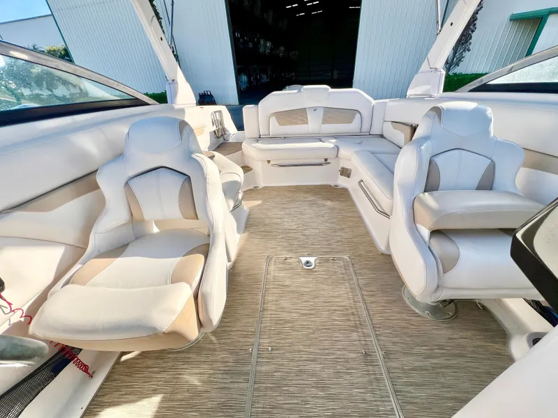 Slide: The Image of Interior of 2018 Four Winns HD270 OB boat with white seating and spacious layout. - 14