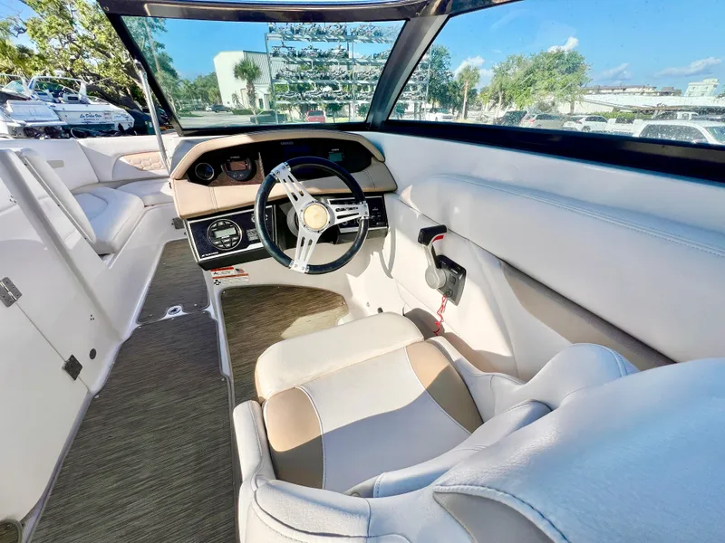Slide: The Image of 2018 Four Winns HD270 OB boat interior with steering wheel and seating, showcasing modern design. - 17