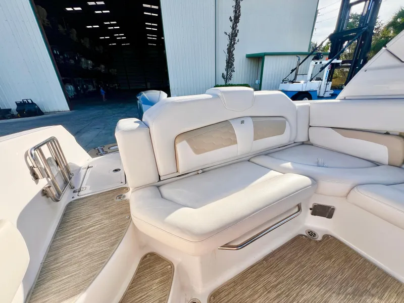 Slide: The Image of 2018 Four Winns HD270 OB boat interior with white cushioned seating. - 9